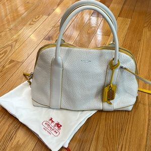 Coach white with yellow trim bag. Can be worn as a cross body. Gently used.